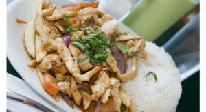 Pollo saltado, an authentic Peruvian dish of chicken, rice and herbs; and the national drink, pisco sour